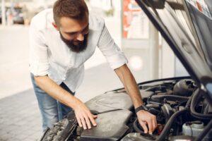 handsome-man-checks-engine-his-car