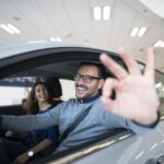 happy-customer-buying-new-car-dealership