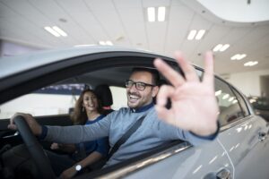 happy-customer-buying-new-car-dealership